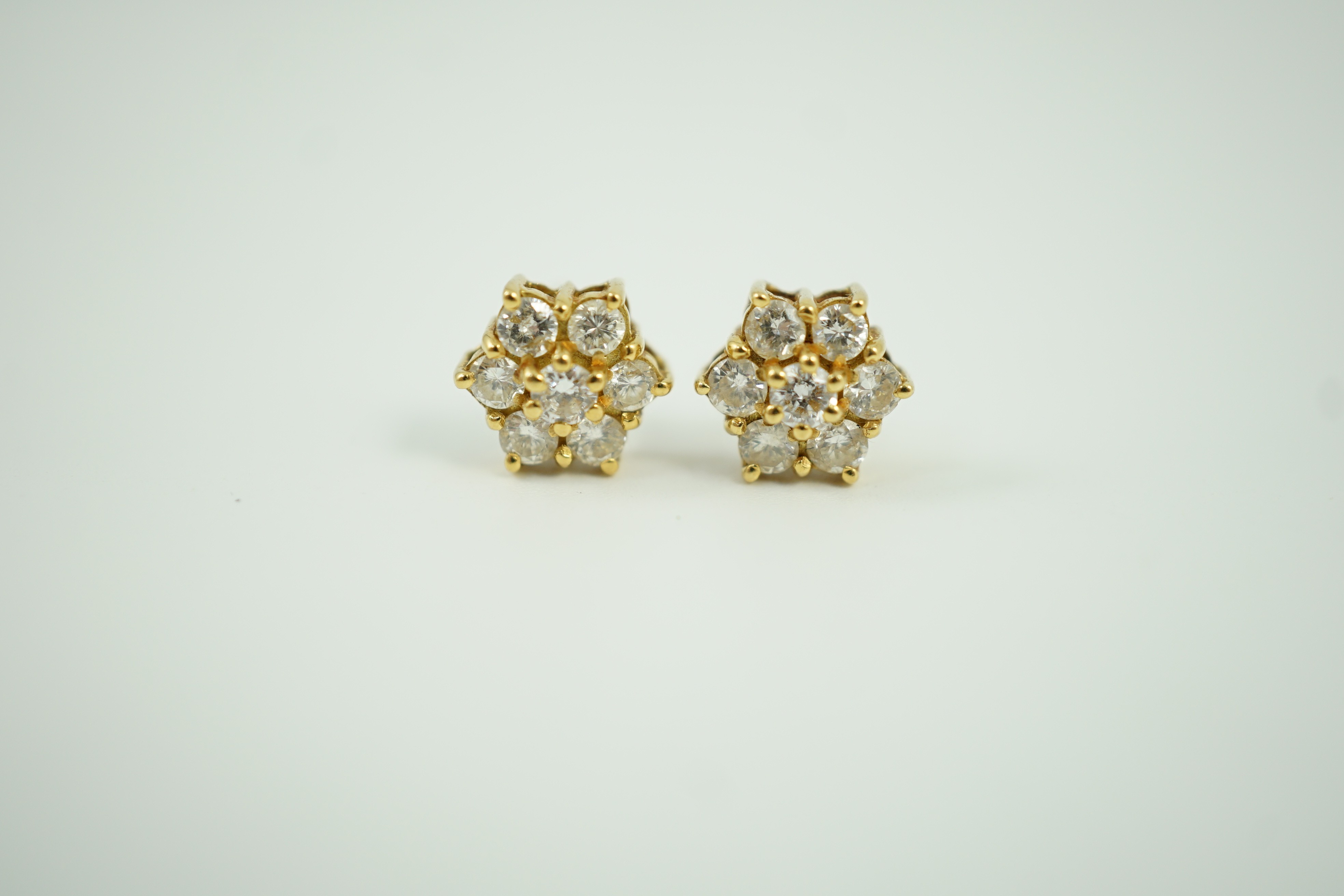 A pair of yellow metal and seven stone diamond cluster set ear studs, 7mm, gross weight 2.8 grams.